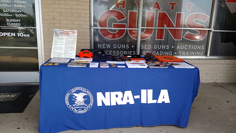 NRA-ILA Table in front of a gun shop to sign up Frontlines Volunteers